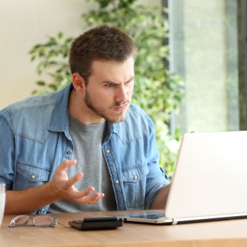 man angry laptop glass of water registry cleaners